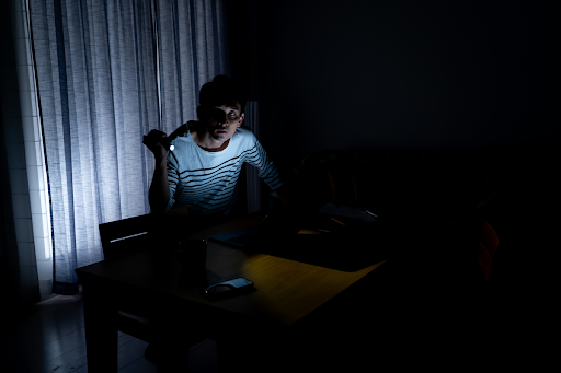 Person sitting in the dark because of a power outage in New Orleans.