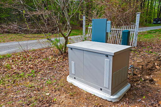 A standby generator installed on a concrete slab outside of a house.