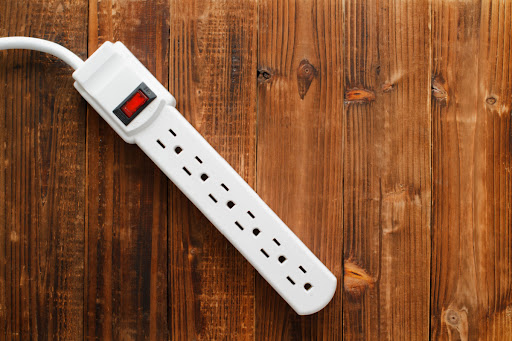 A power strip against a wood surface.