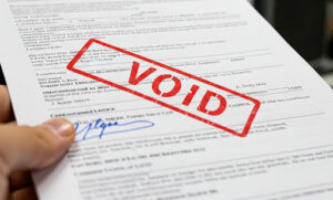 A paper with a signature that has "void" stamped on it in red.
